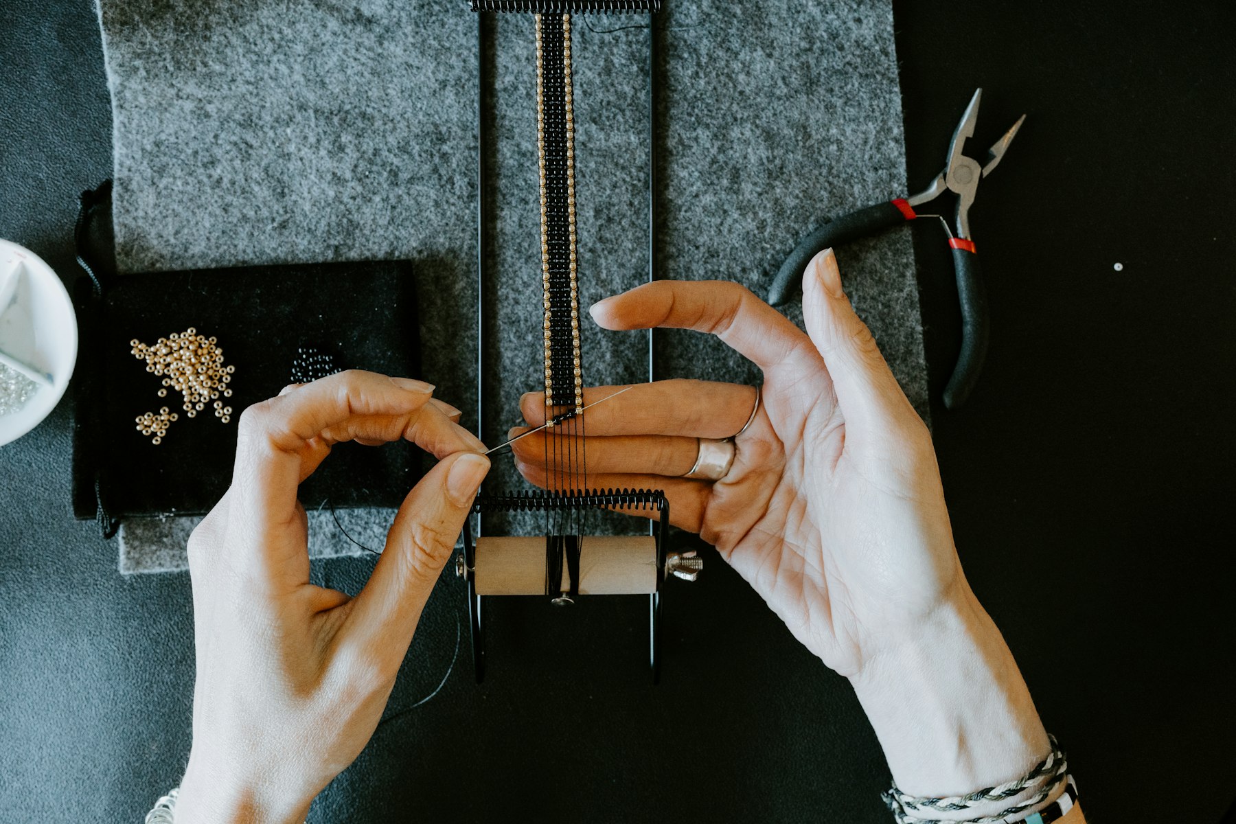 A jeweller working at her bench